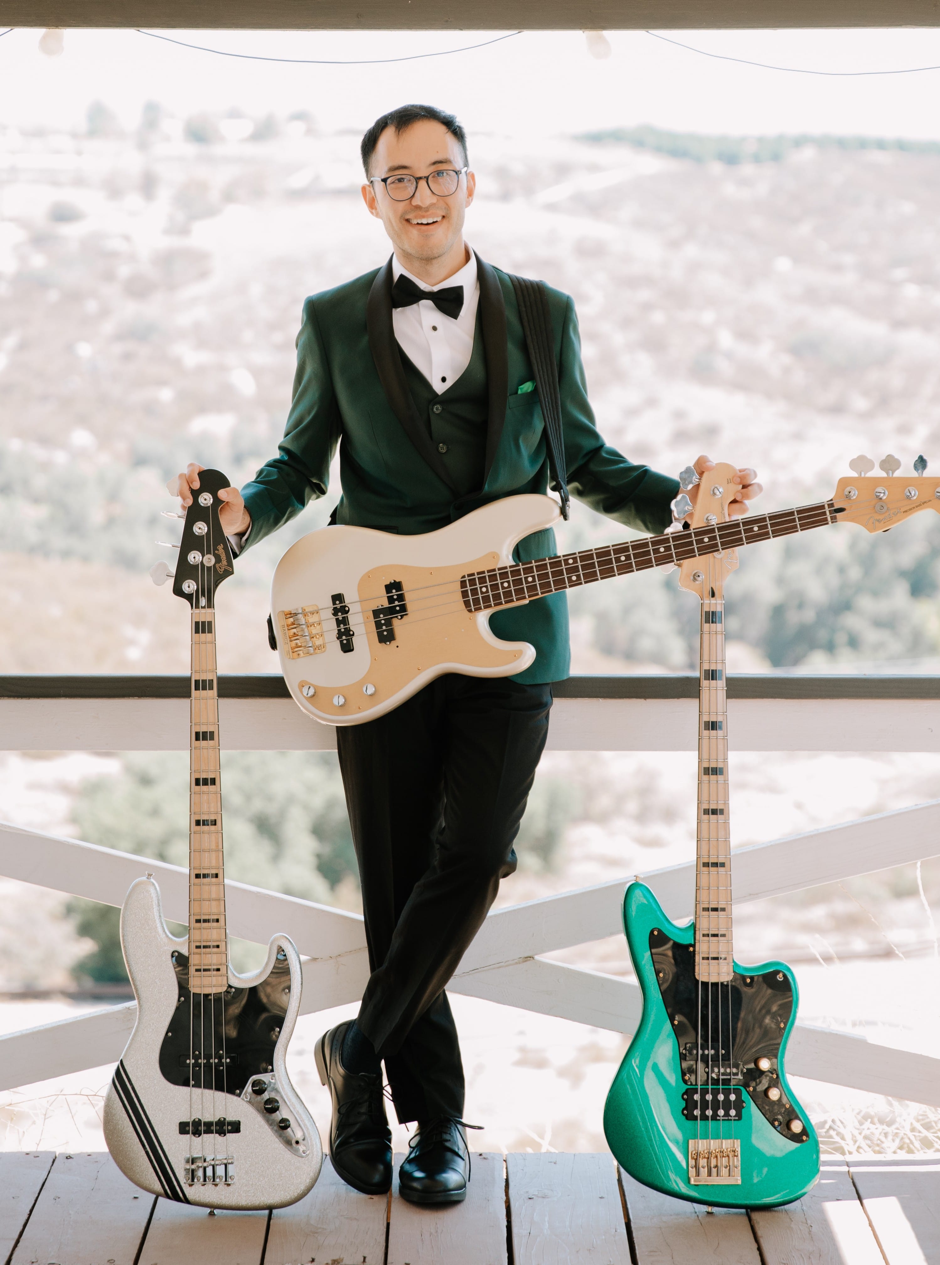 Chris in a tux with three basses